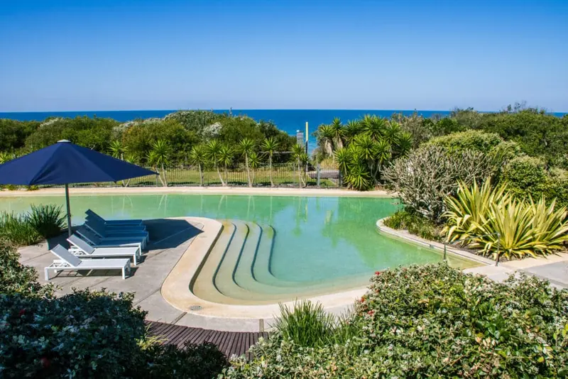 View across the resort swimming pool towards Diamond Beach