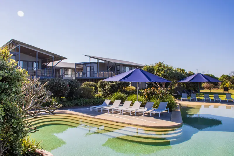 Swimming pool, sun lounges and beach houses at Serenity Diamond Beach