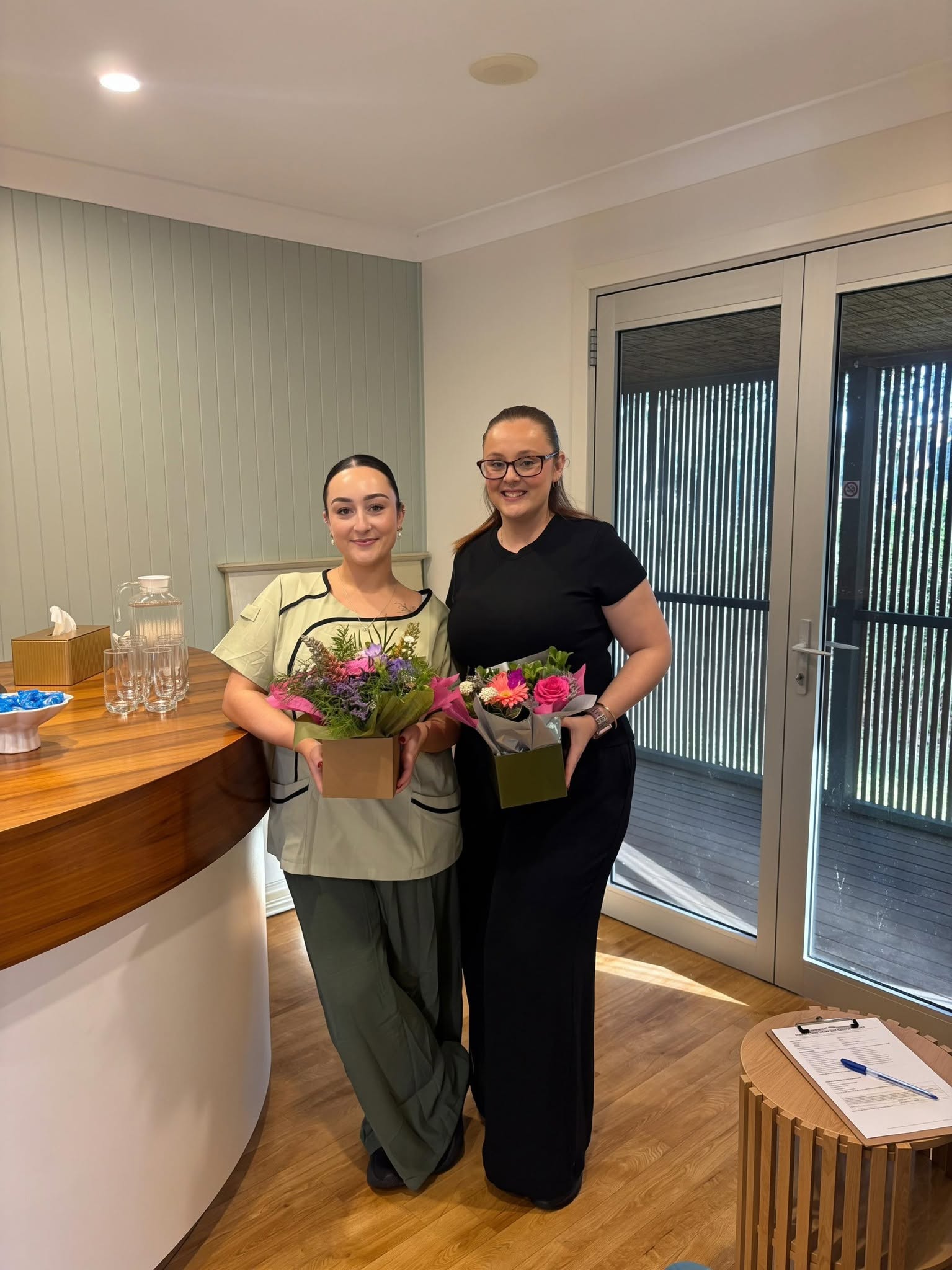 Two members of the Queen of Hearts Serenity Spa team at reception